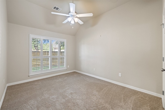 spare room with ceiling fan, lofted ceiling, and carpet