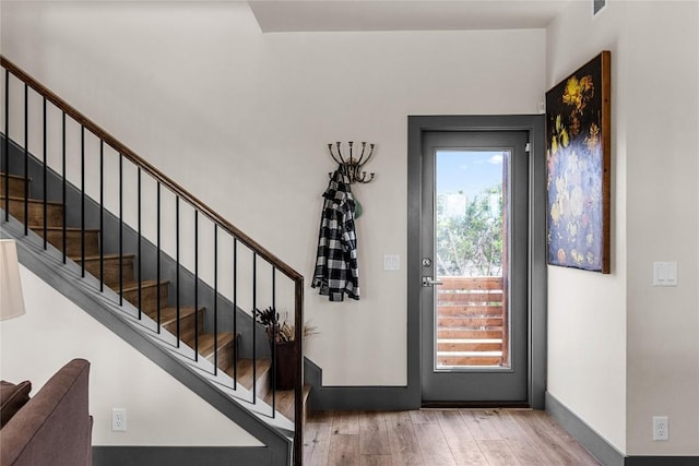 entryway with hardwood / wood-style floors and a healthy amount of sunlight