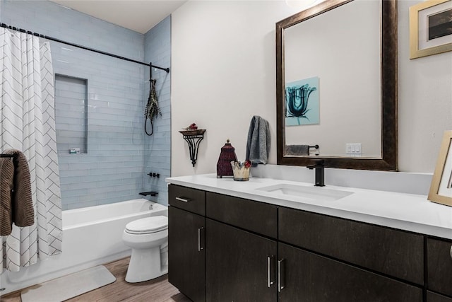 full bathroom with vanity, toilet, shower / bathtub combination with curtain, and hardwood / wood-style flooring