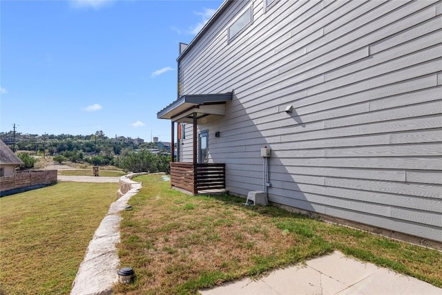 view of side of home featuring a yard