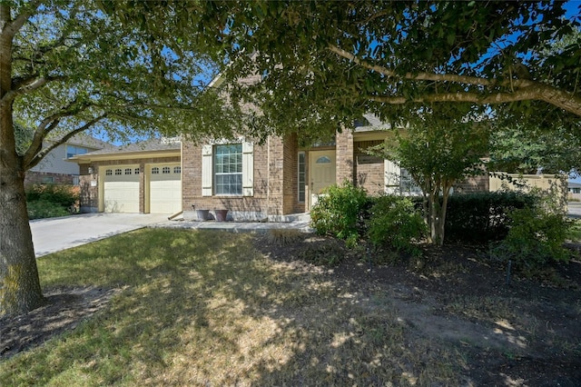 view of property hidden behind natural elements featuring a front yard and a garage