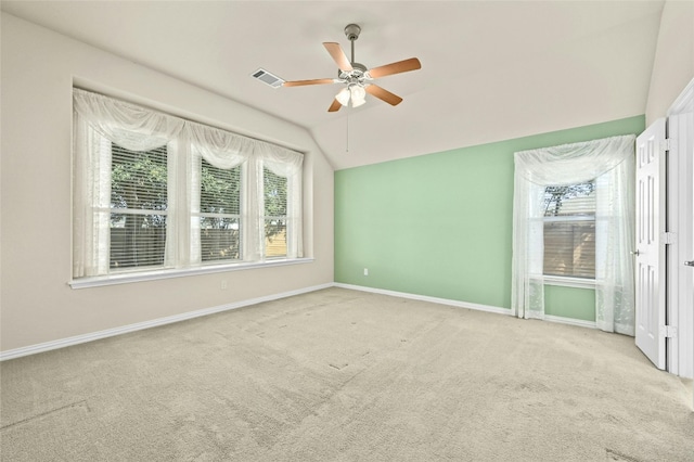 unfurnished room featuring vaulted ceiling, ceiling fan, and light colored carpet