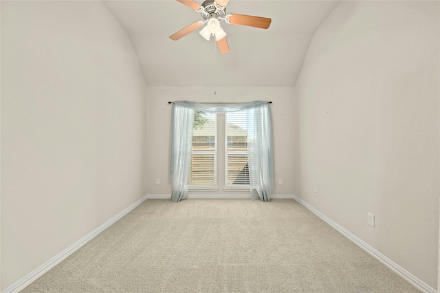 carpeted empty room with ceiling fan and lofted ceiling