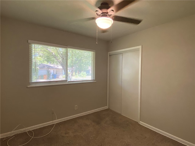 unfurnished bedroom with multiple windows, ceiling fan, a closet, and carpet floors