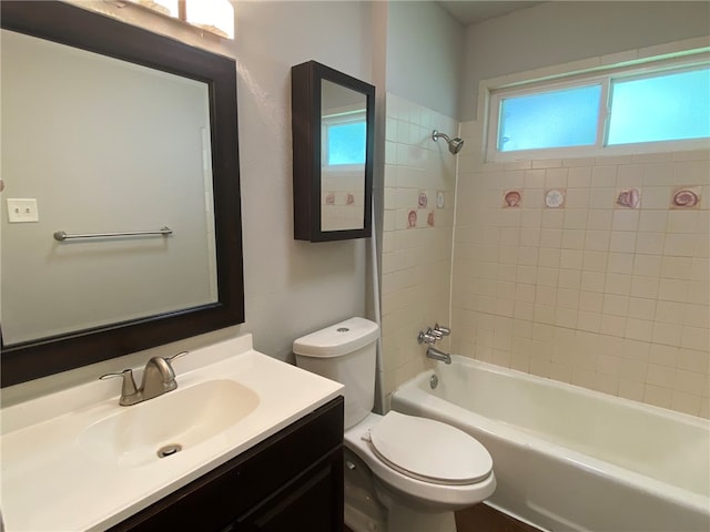 full bathroom with tiled shower / bath combo, vanity, and toilet