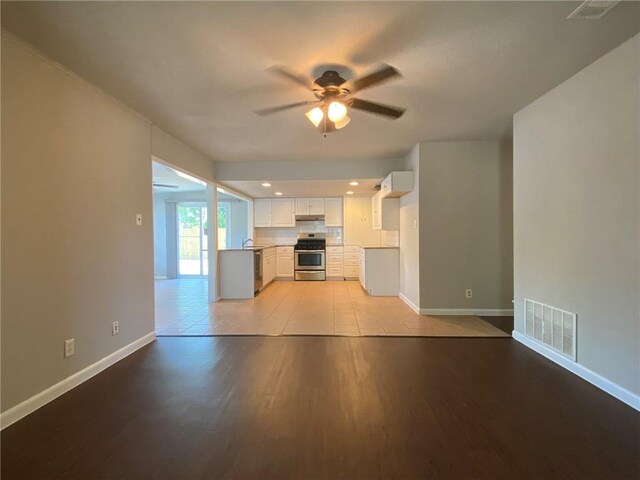 unfurnished living room with light hardwood / wood-style flooring and ceiling fan