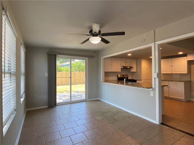 kitchen featuring white cabinets, ceiling fan, stainless steel range oven, and tile patterned floors