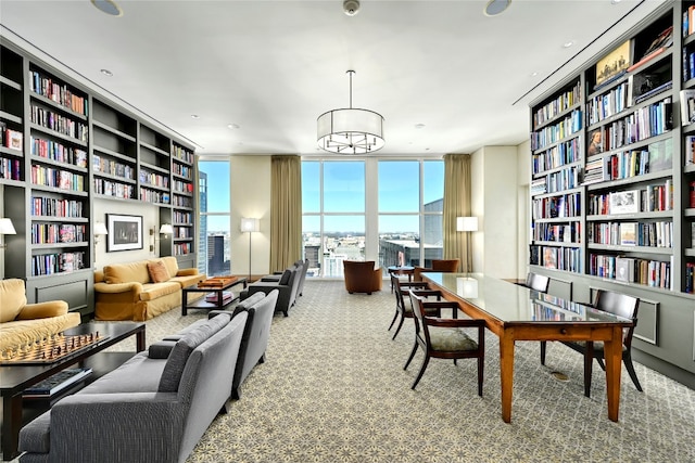 living area with expansive windows, built in features, and carpet flooring