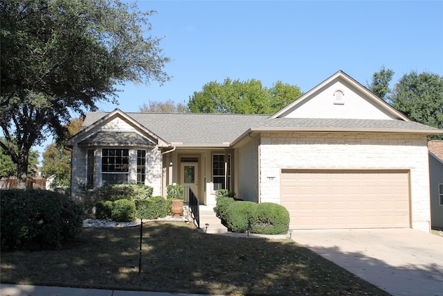 ranch-style home featuring driveway, an attached garage, and a shingled roof