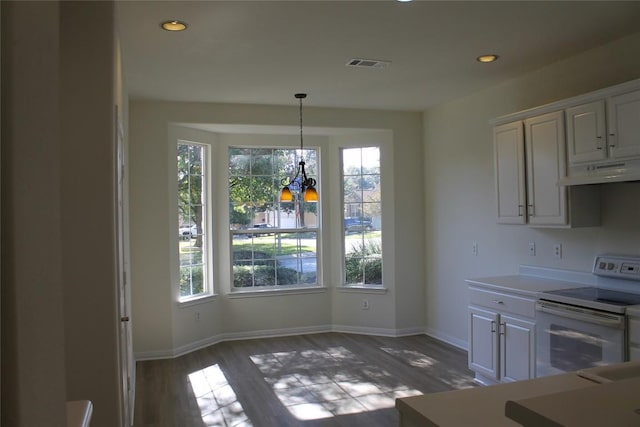 unfurnished dining area with baseboards, visible vents, wood finished floors, an inviting chandelier, and recessed lighting