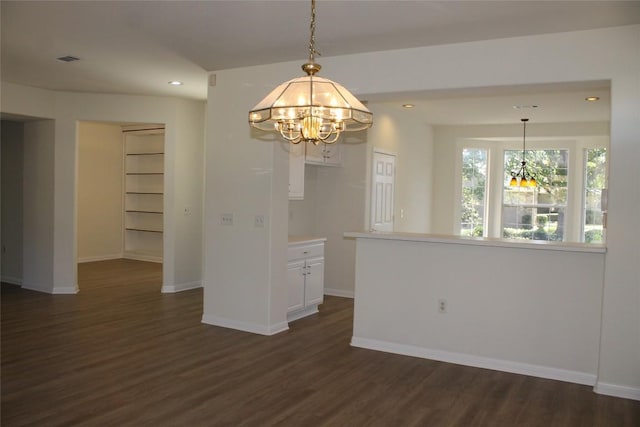 unfurnished dining area featuring a chandelier, recessed lighting, baseboards, and dark wood-style floors