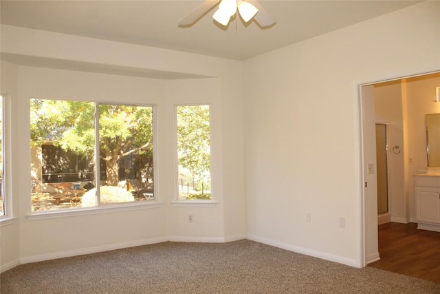 unfurnished room with carpet, baseboards, and ceiling fan