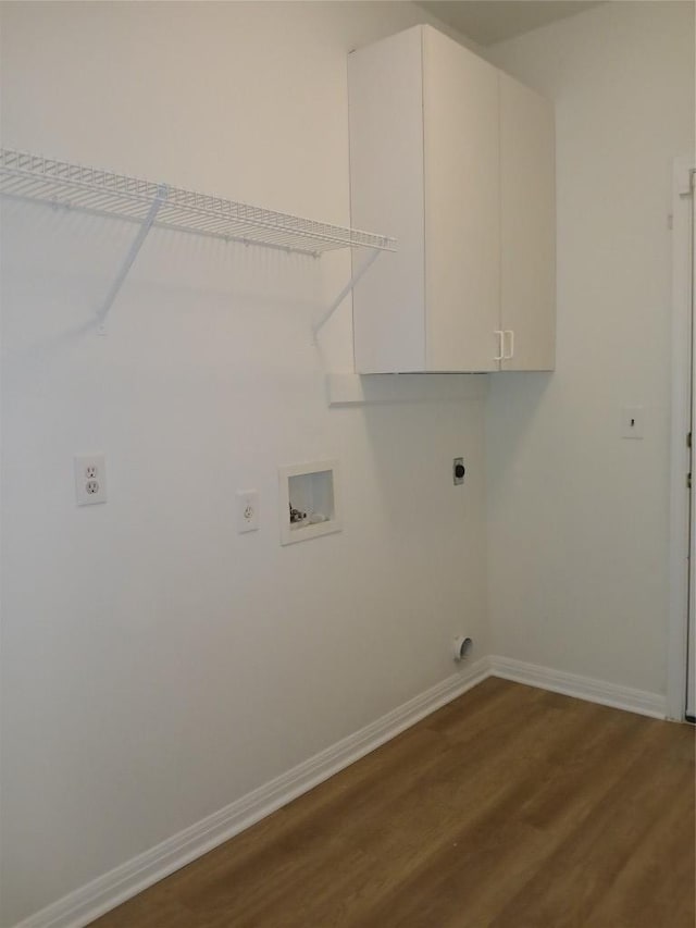 washroom with baseboards, washer hookup, cabinet space, and electric dryer hookup