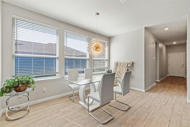 dining area with a chandelier and light wood-type flooring