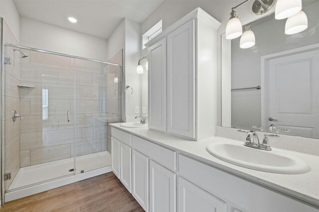 3017 Settlement Dr Unit 30, Round Rock, TX 78665 - bathroom with a shower stall, double vanity, wood finished floors, and recessed lighting