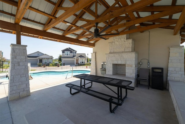 view of pool featuring a patio area, ceiling fan, and an outdoor stone fireplace