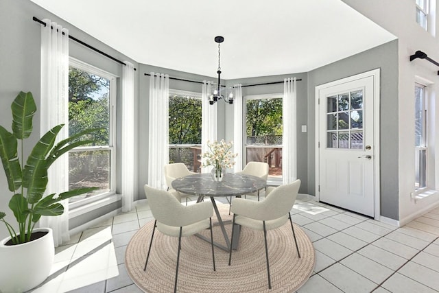 sunroom featuring a notable chandelier and plenty of natural light