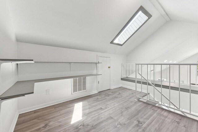 interior space with light hardwood / wood-style flooring and lofted ceiling