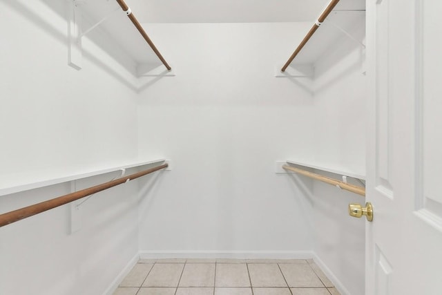 spacious closet with light tile patterned floors