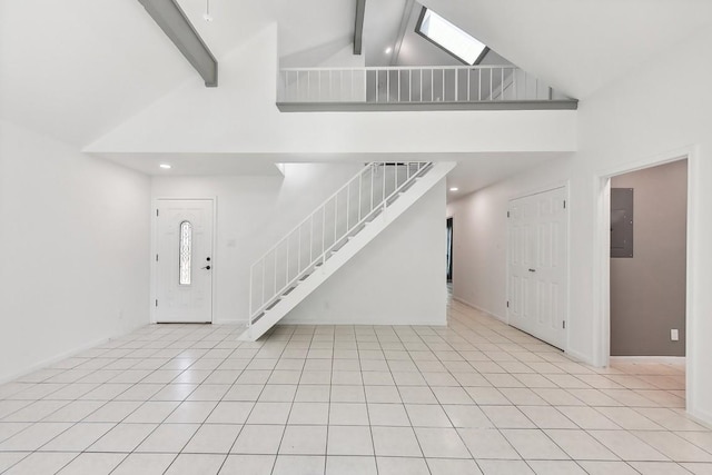 foyer entrance featuring beamed ceiling, high vaulted ceiling, and light tile patterned flooring