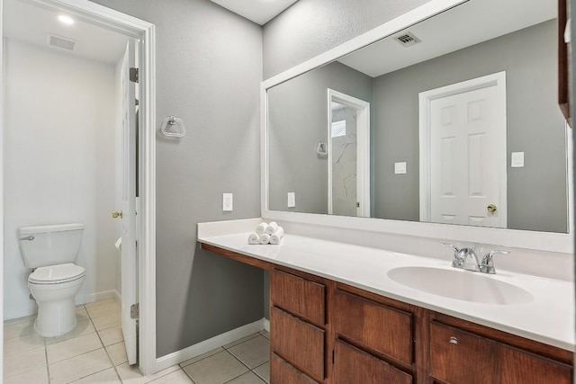 bathroom featuring toilet, vanity, and tile patterned floors