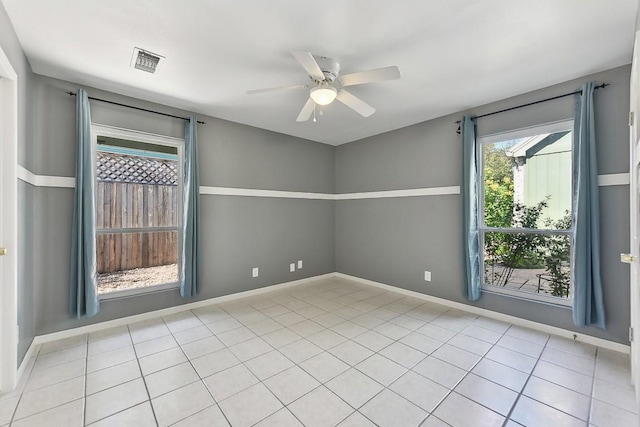 unfurnished room with ceiling fan and light tile patterned floors