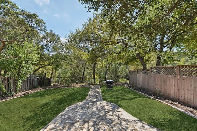 view of yard with a fenced backyard