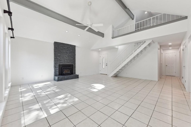 unfurnished living room with light tile patterned floors, ceiling fan, high vaulted ceiling, stairway, and beamed ceiling