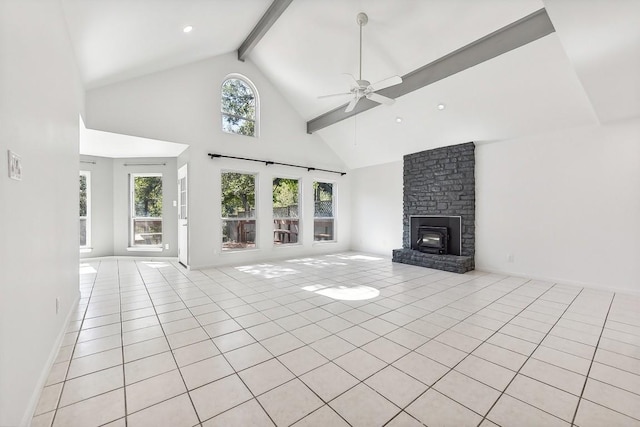 unfurnished living room featuring high vaulted ceiling, light tile patterned flooring, a fireplace, a ceiling fan, and beam ceiling