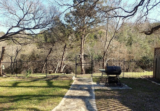 view of property's community with fence and a lawn