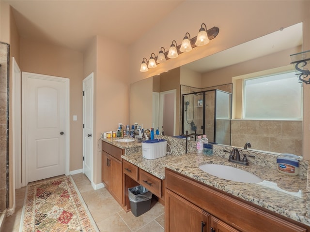 bathroom with vanity, a shower with shower door, and tile patterned floors