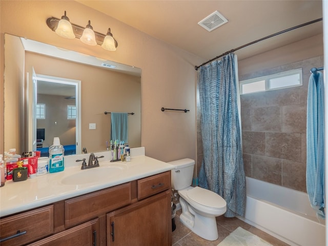 full bathroom with shower / bath combination with curtain, tile patterned floors, vanity, and toilet