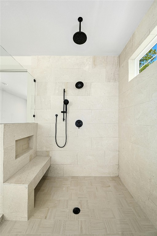 bathroom featuring a tile shower