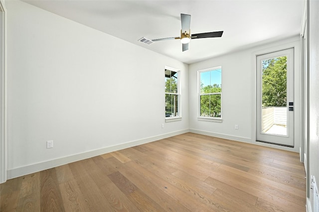 spare room with ceiling fan and light wood-type flooring