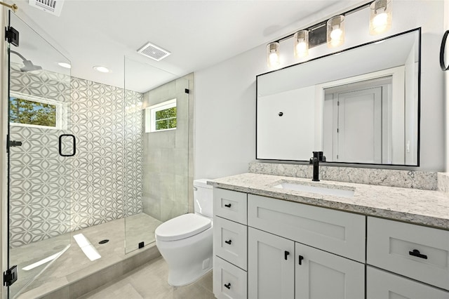 bathroom featuring tile patterned floors, toilet, walk in shower, and vanity