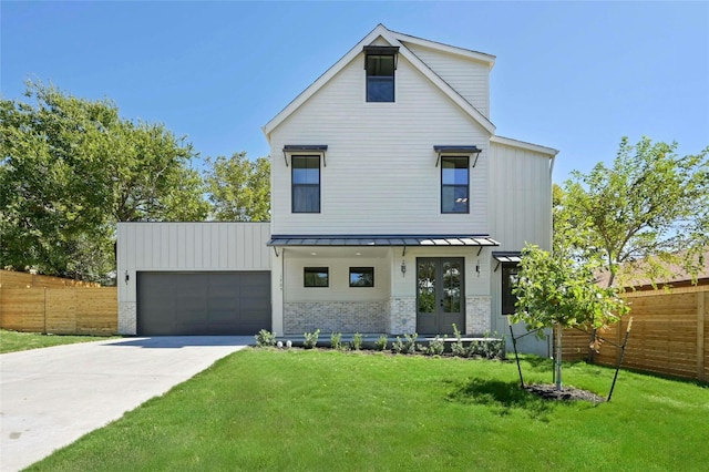 modern farmhouse style home with a garage, a front yard, and french doors