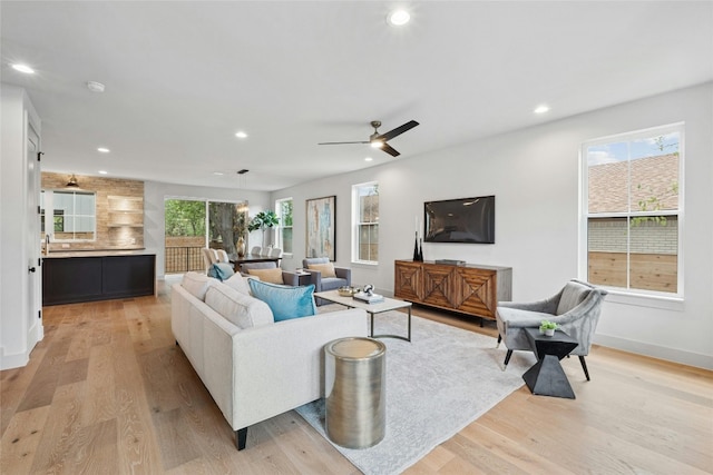 living room with light wood-type flooring and a healthy amount of sunlight