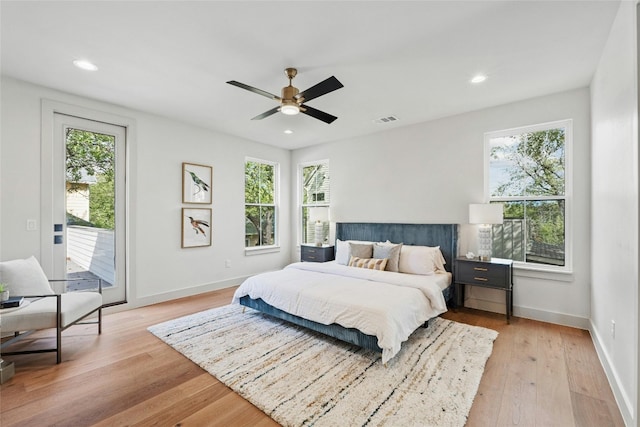 bedroom with light hardwood / wood-style flooring, ceiling fan, and access to outside