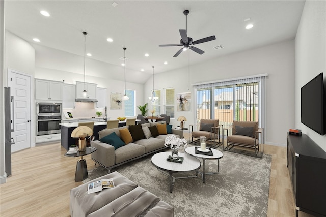 living room featuring ceiling fan, light wood-type flooring, and vaulted ceiling