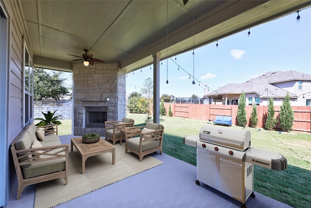 view of patio / terrace featuring an outdoor living space with a fireplace, grilling area, and ceiling fan