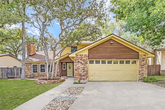 view of front of house featuring a garage and a front lawn