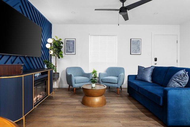 living room with dark hardwood / wood-style flooring and ceiling fan