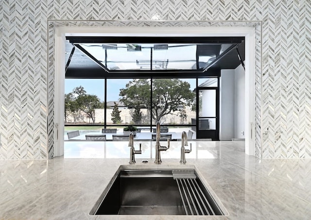 kitchen with light stone counters and sink