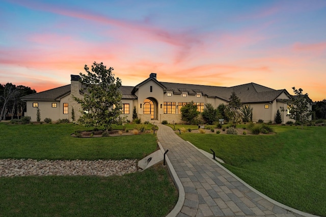 french provincial home featuring a lawn