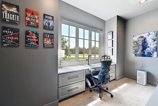 office area featuring built in desk and light hardwood / wood-style floors