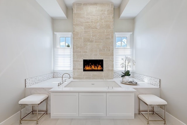 interior space with a bath and a fireplace