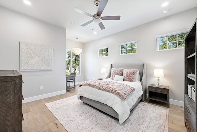 bedroom with light hardwood / wood-style flooring and ceiling fan