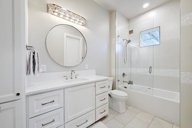 full bathroom featuring vanity, bath / shower combo with glass door, tile patterned floors, and toilet