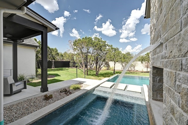 view of pool featuring a lawn and pool water feature