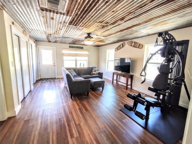 exercise room with ceiling fan and dark hardwood / wood-style floors